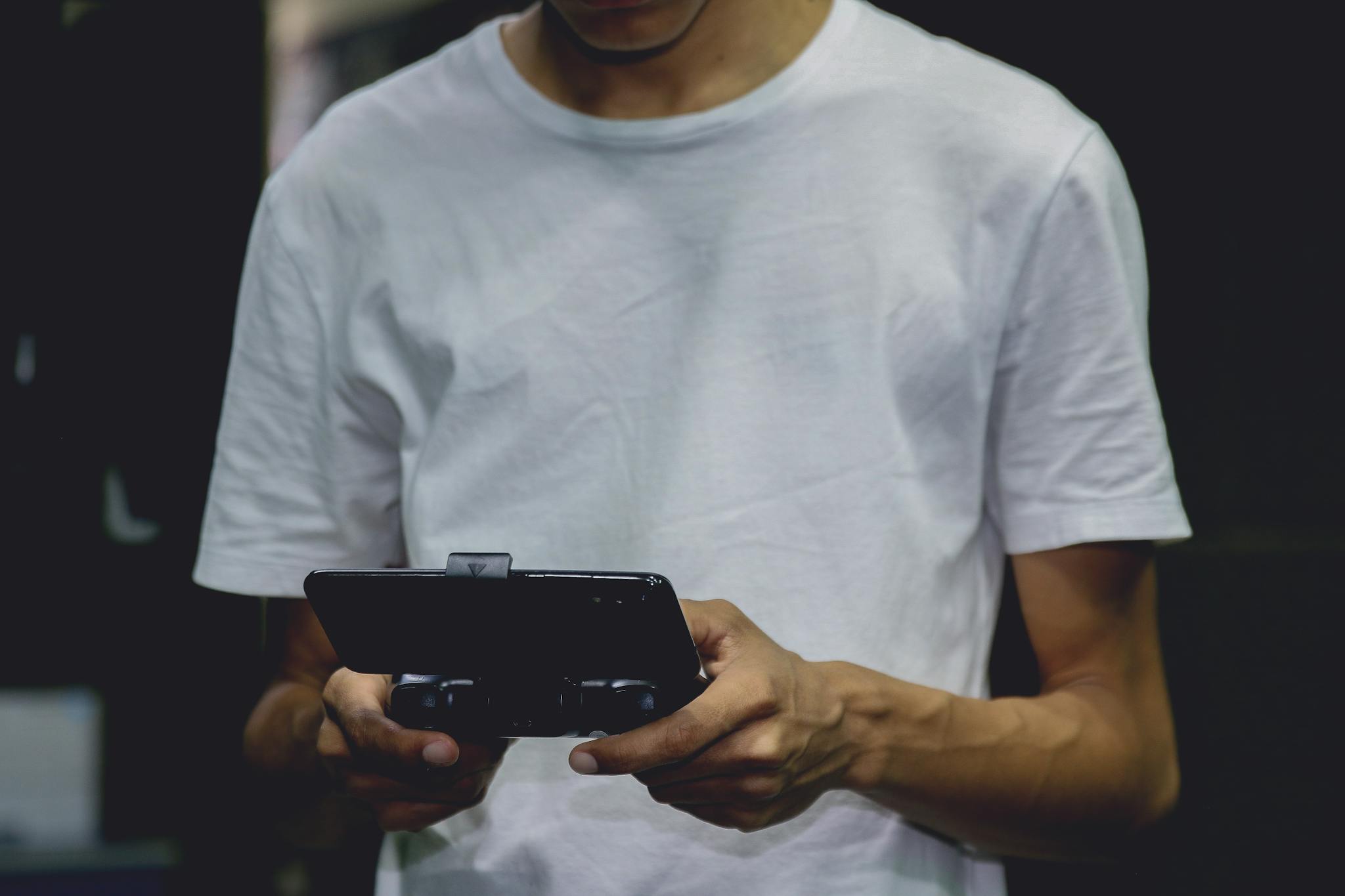 a smartphone game controller on a persons