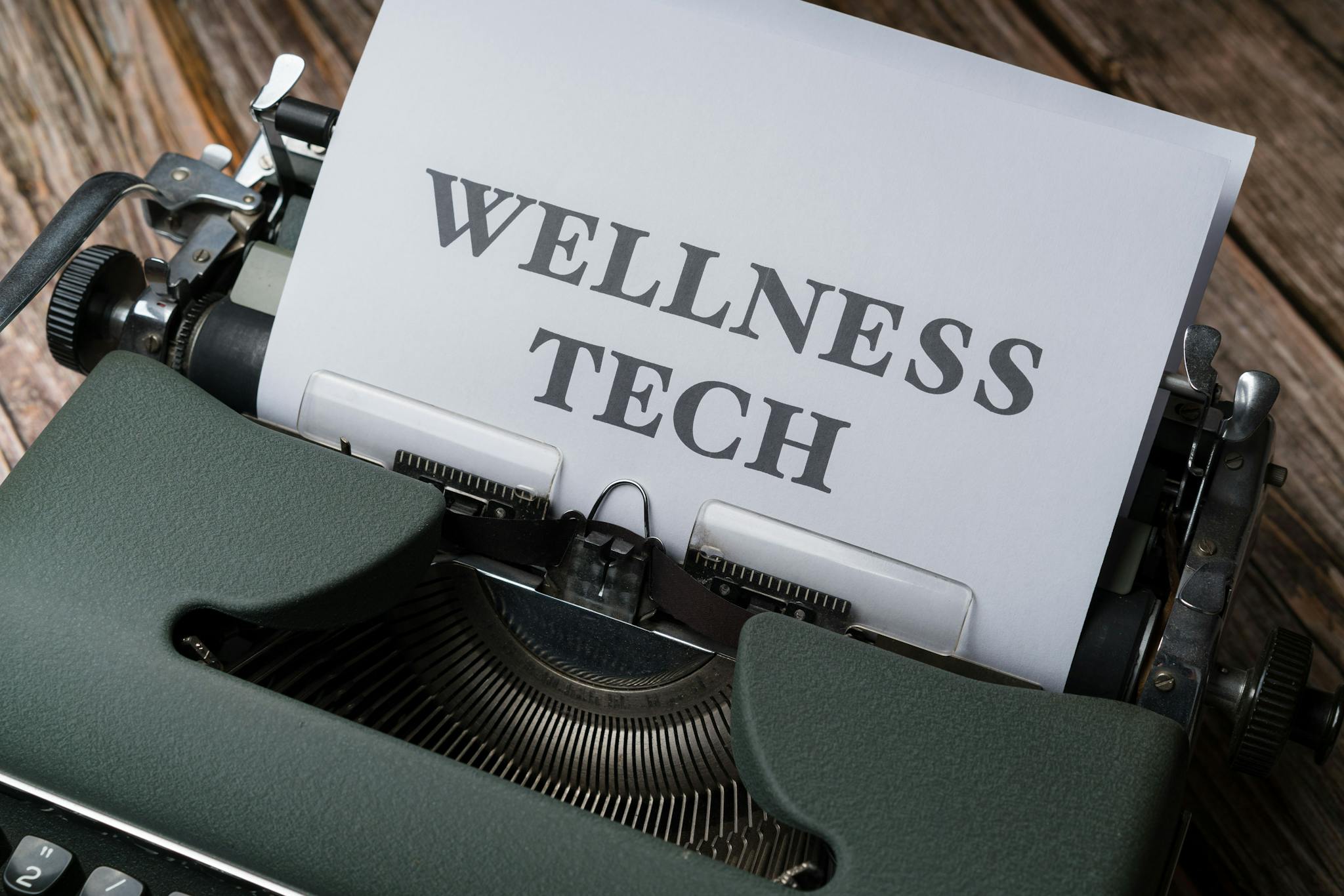 a typewriter with the word wellness tech